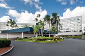 Parking and hotel exterior at Sonesta Miami Airport.