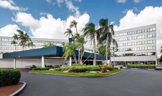 Parking and hotel exterior at Sonesta Miami Airport.