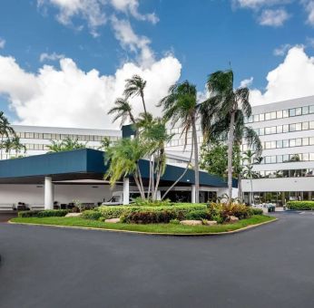 Parking and hotel exterior at Sonesta Miami Airport.