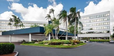 Parking and hotel exterior at Sonesta Miami Airport.