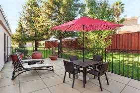 Outdoor garden and terrace at Hampton Inn Tracy.