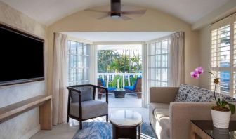 Spacious king room with TV and lounge at Royal Sonesta San Juan.