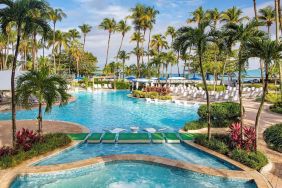 Outdoor pool with palm trees at Royal Sonesta San Juan.