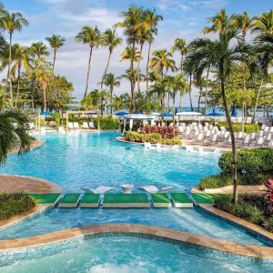 Outdoor pool with palm trees at Royal Sonesta San Juan.