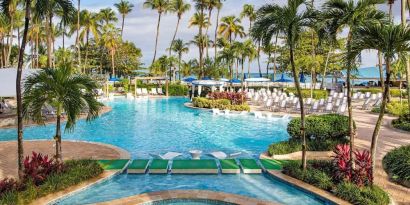 Outdoor pool with palm trees at Royal Sonesta San Juan.