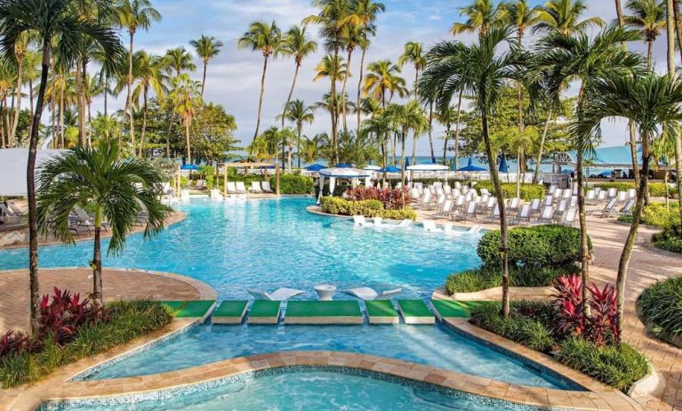 Outdoor pool with palm trees at Royal Sonesta San Juan.