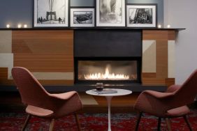 Cozy lounge with fire place at The Fifty Sonesta Select New York.