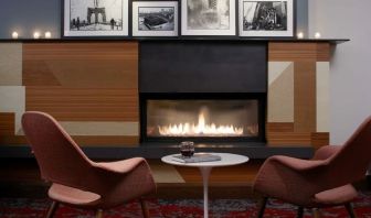 Cozy lounge with fire place at The Fifty Sonesta Select New York.