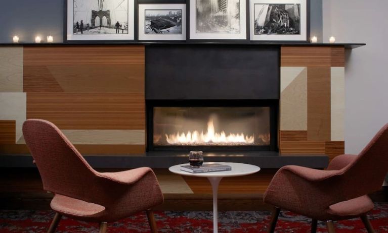 Cozy lounge with fire place at The Fifty Sonesta Select New York.