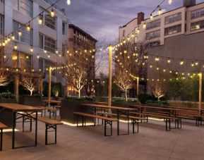 Outdoor lounge with night lights at The Tillary Hotel.