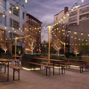 Outdoor lounge with night lights at The Tillary Hotel.