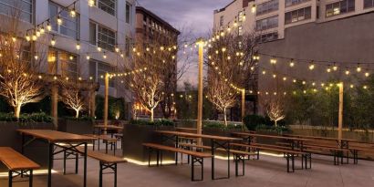 Outdoor lounge with night lights at The Tillary Hotel.