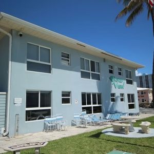 Hotel with lounge chairs at Shore View Hotel.