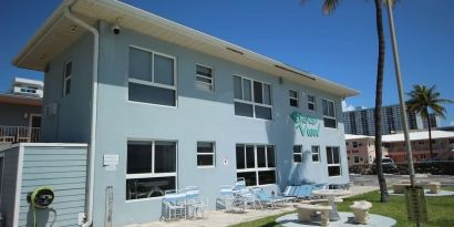 Hotel with lounge chairs at Shore View Hotel.