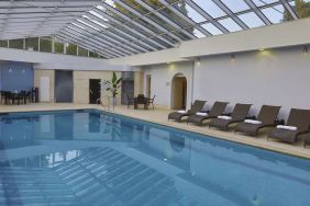 Indoor pool with seating area at DoubleTree By Hilton Oxford Belfry.