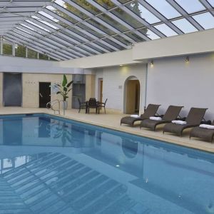 Indoor pool with seating area at DoubleTree By Hilton Oxford Belfry.