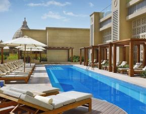 Pool lounge chairs at Hilton Dubai Al Habtoor City.