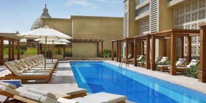 Pool lounge chairs at Hilton Dubai Al Habtoor City.