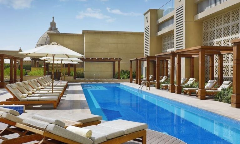 Pool lounge chairs at Hilton Dubai Al Habtoor City.