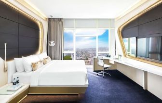 Spacious king room with TV at V Hotel Dubai.