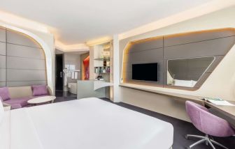 Well-lit king room at V Hotel Dubai.