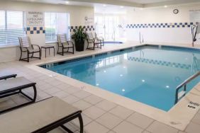 Indoor pool with lounge chairs at Hilton Garden Inn Kennett Square.