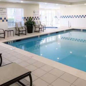 Indoor pool with lounge chairs at Hilton Garden Inn Kennett Square.