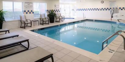 Indoor pool with lounge chairs at Hilton Garden Inn Kennett Square.