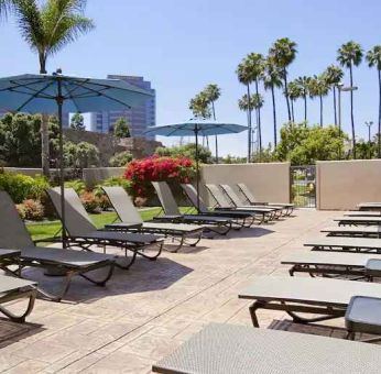 Pool with pool chairs at Embassy Suites By Hilton San Diego-La Jolla.