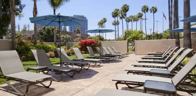 Pool with pool chairs at Embassy Suites By Hilton San Diego-La Jolla.