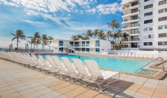 Outdoor pool and palm trees at New Point Miami.