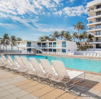 Outdoor pool and palm trees at New Point Miami.