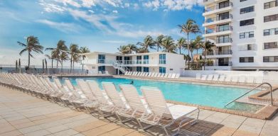 Outdoor pool and palm trees at New Point Miami.