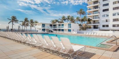 Outdoor pool and palm trees at New Point Miami.