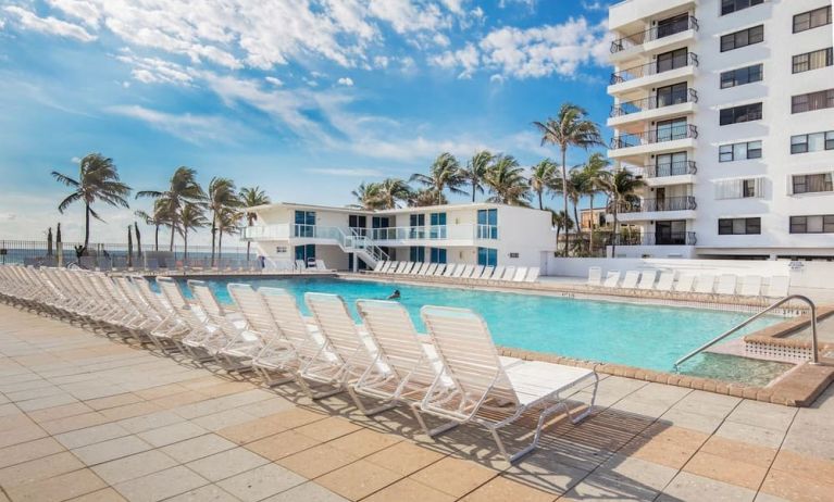 Outdoor pool and palm trees at New Point Miami.