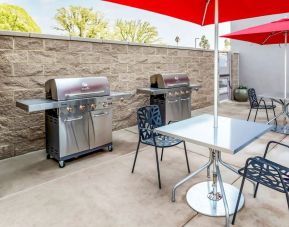 Outdoor terrace and barbeque area at Home2 Suites By Hilton West Sacramento.