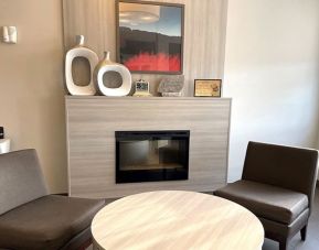 Coworking and fire place at Coratel Inn & Suites By Jasper Rochester.