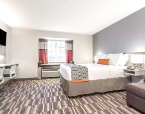 Spacious king room with TV at Coratel Inn & Suites By Jasper Rochester.