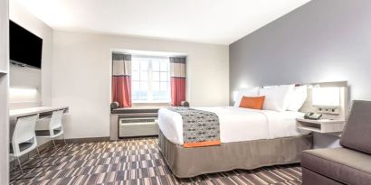 Spacious king room with TV at Coratel Inn & Suites By Jasper Rochester.