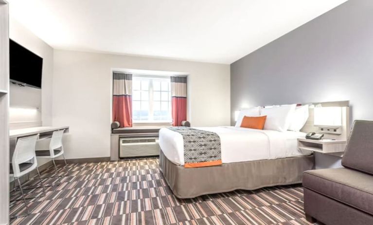 Spacious king room with TV at Coratel Inn & Suites By Jasper Rochester.