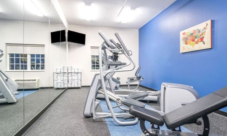 Fitness center at Coratel Inn & Suites By Jasper Rochester.