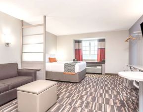 Spacious king suite at Coratel Inn & Suites By Jasper Rochester.