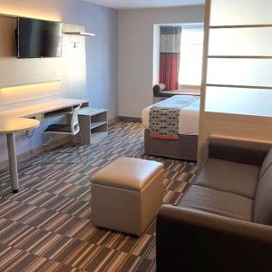 King suite with lounge area at Coratel Inn & Suites By Jasper Rochester.