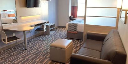 King suite with lounge area at Coratel Inn & Suites By Jasper Rochester.