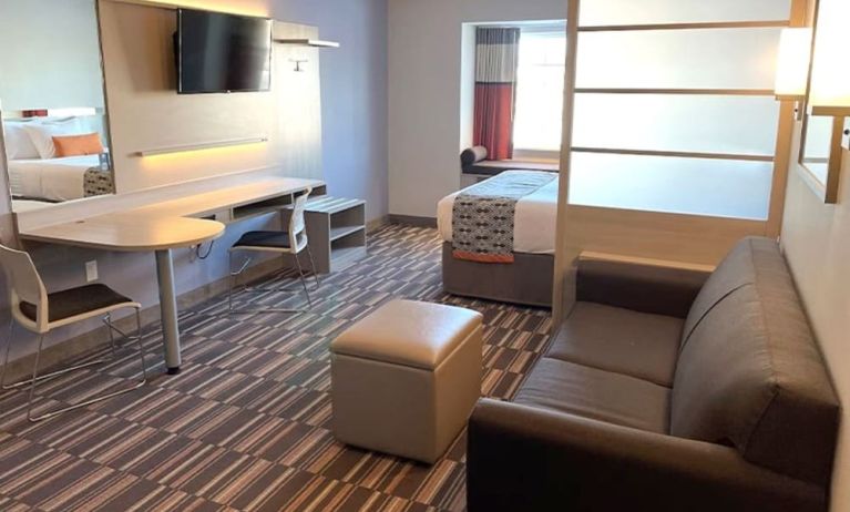 King suite with lounge area at Coratel Inn & Suites By Jasper Rochester.