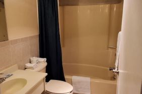 Guest bathroom with shower at Bay Breeze Motel.