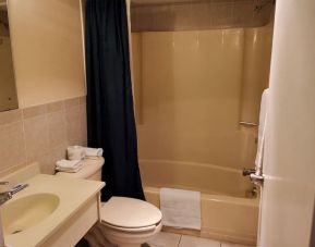 Guest bathroom with shower at Bay Breeze Motel.
