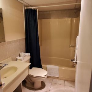 Guest bathroom with shower at Bay Breeze Motel.