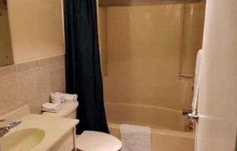 Guest bathroom with shower at Bay Breeze Motel.