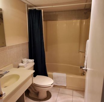 Guest bathroom with shower at Bay Breeze Motel.